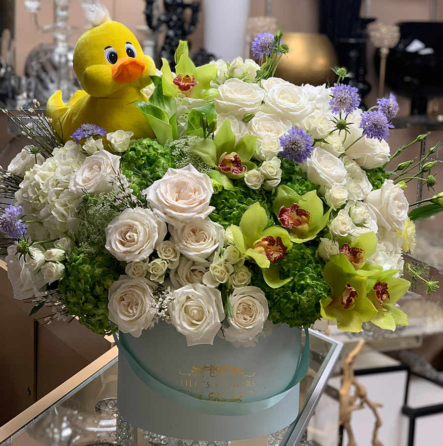 elegant bouquet in the baby blue hat box, white roses , white  spray roses, green orchids